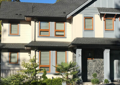 Cream townhomes with orange-framed windows and grey columns