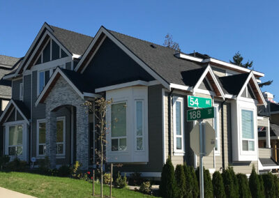 Home with grey and stone cladding at a street corner